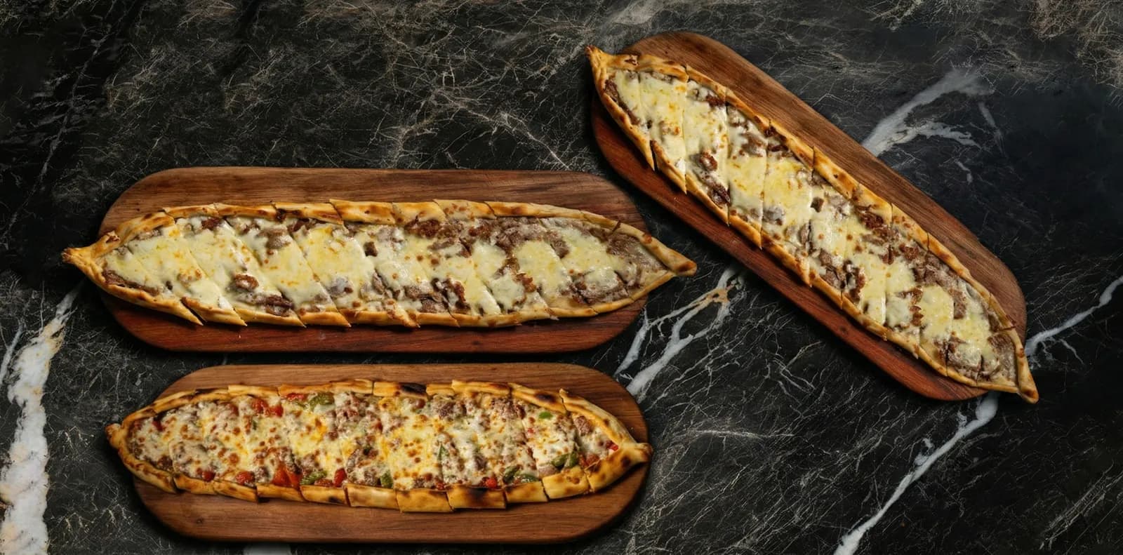 Stone-baked Turkish pide on wooden boards